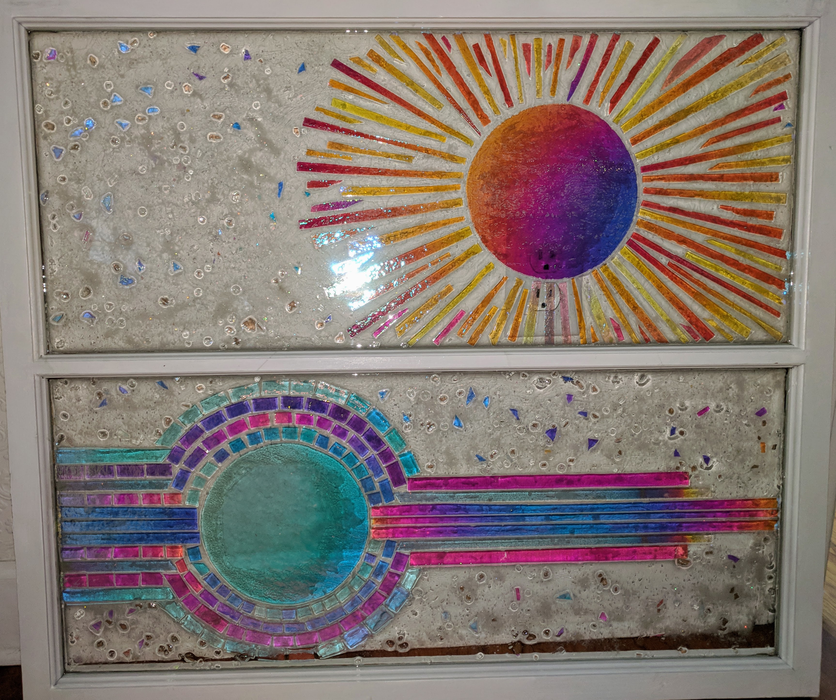Art Deco sun / moon dichroic glass set in resin in recycled window